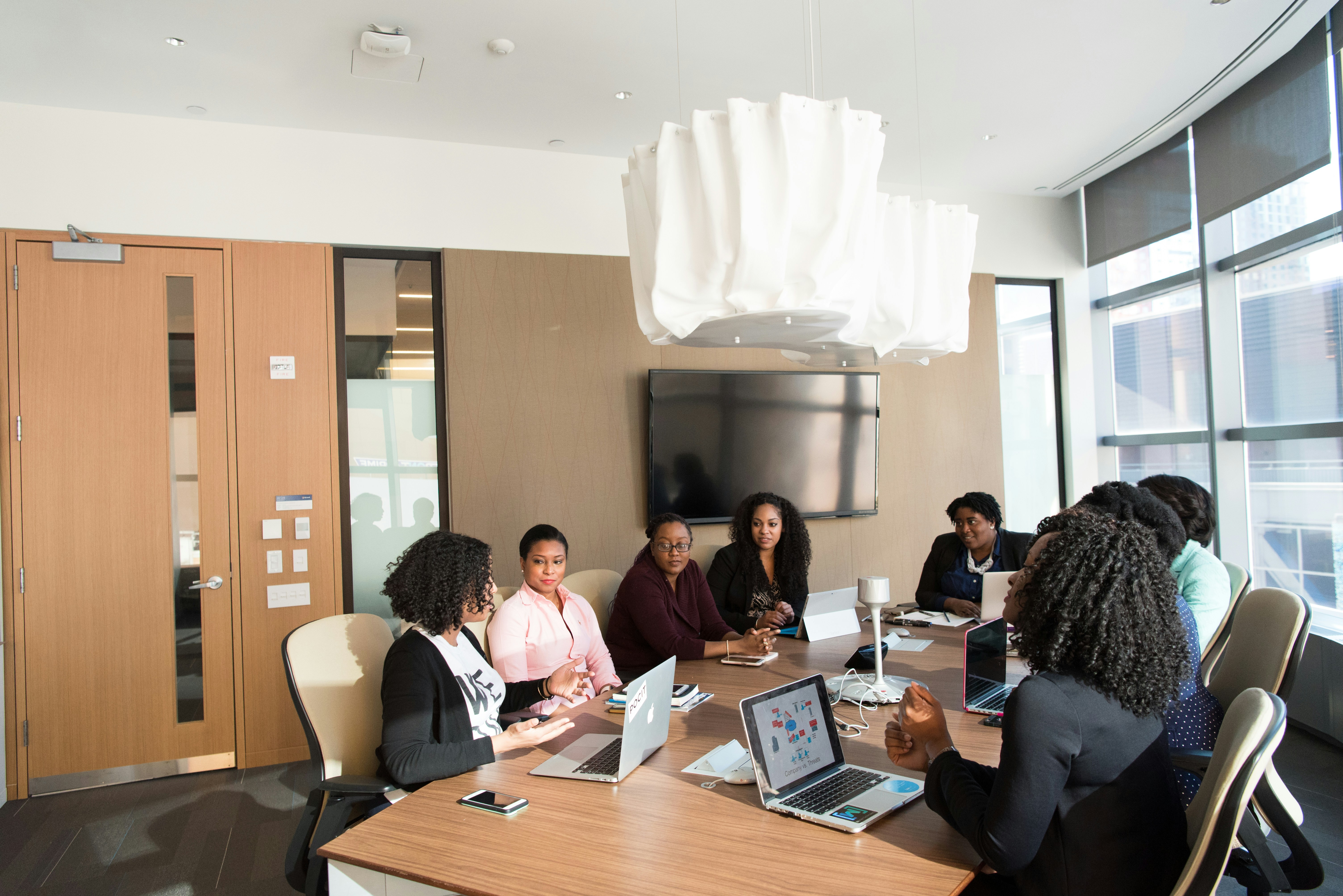 a group of women doing a business meeting